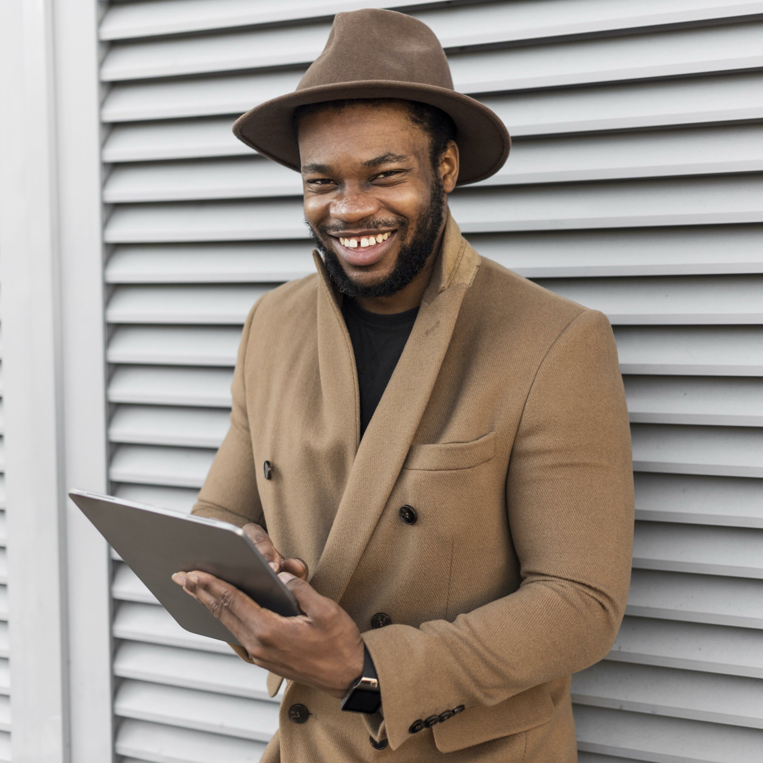 smiley-modern-man-holding-tablet